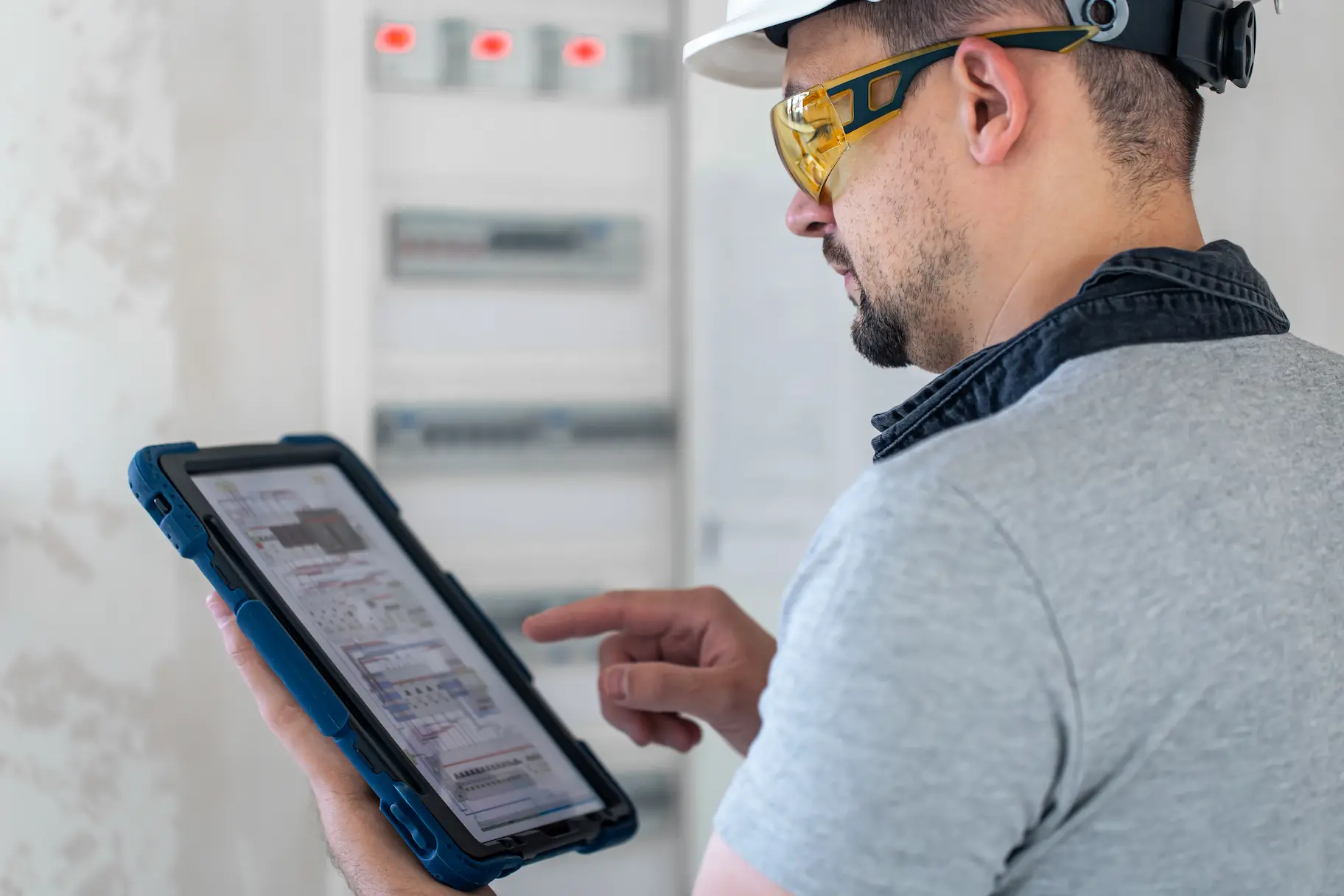 electrical-technician-looking-focused-while-working-switchboard-with-fuses